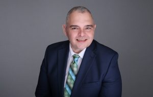 Man facing forward and smiling