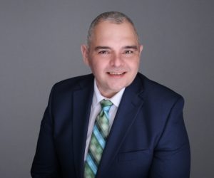 Man facing forward and smiling