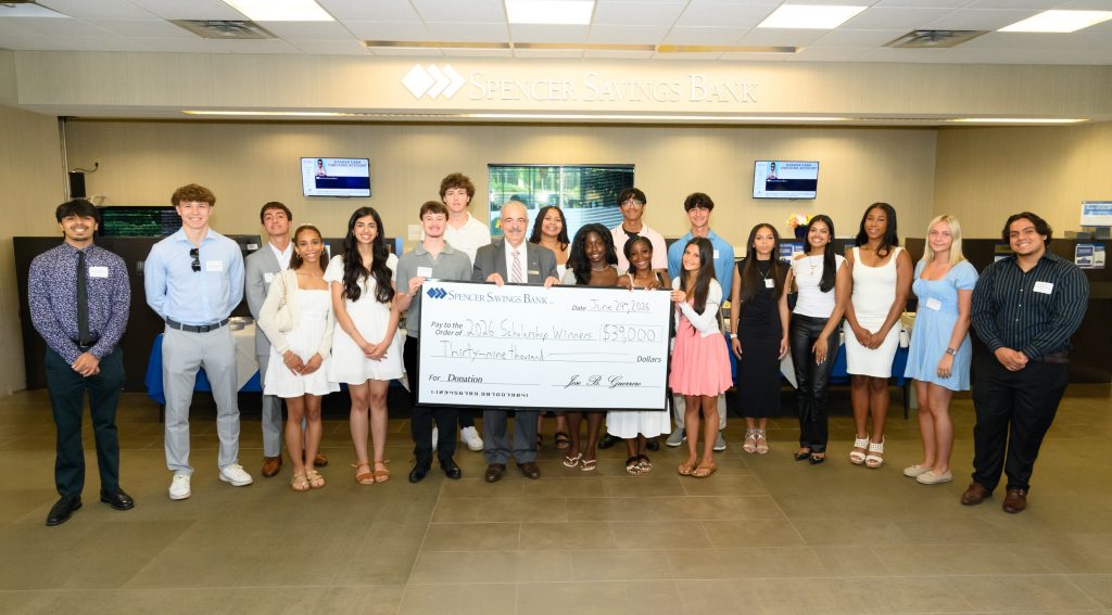scholarship check presented to students by ceo/president of Spencer Savings Bank